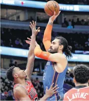  ?? [AP PHOTO] ?? Oklahoma City Thunder center Steven Adams, right, shoots over Chicago Bulls center Wendell Carter Jr. during Friday’s game in Chicago.