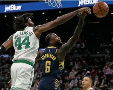  ?? MATT sTONE PHOTOs / BOsTON HErALd ?? GET OUT OF HERE: Robert Williams blocks the shot of Indiana’s Lance Stephenson during the first half.