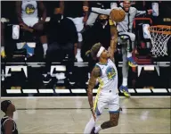  ?? KATHY WILLENS — THE ASSOCIATED PRESS, FILE ?? Nets guard Caris LeVert, far left, watches as Warriors forward Kelly Oubre Jr., dunks the ball during the first quarter on Tuesday in New York.