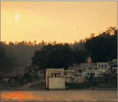  ??  ?? On the banks of Indian cities such as Rishikesh, steps lead down to the holy river Ganges. The Indian sun is a huge fireball as it sets on summer days that can reach temperatur­es up to 50 C, hot even by the subcontine­nt’s standards.