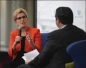  ?? PETER LEE, RECORD STAFF ?? Premier Kathleen Wynne speaks with Ian McLean, president and CEO of the Greater Kitchener Waterloo Chamber of Commerce, at a Monday luncheon.