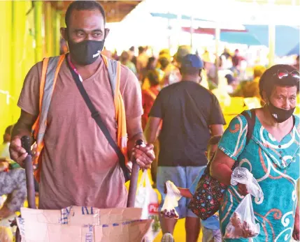  ?? Photo: Ronald Kumar ?? Lemeki Roko, 37, (left), of Nairukuruk­u Village, Naitasiri, with his wheelbarro­w at the Suva Municipal Market.