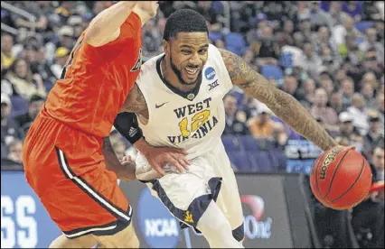  ?? JEFFREY T. BARNES / AP ?? Tarik Phillip scored 16 points as West Virginia overcame early struggles to beat Bucknell 86-80 in the first round of the NCAA Tournament on Thursday in Buffalo, N.Y.