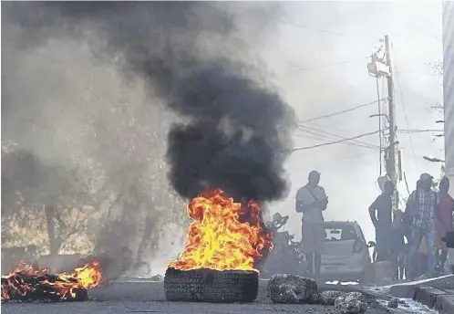  ?? ?? Armed gangs calling for the resignatio­n of prime minister Ariel Henry, below, have created havoc in Haiti leaving many dead