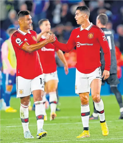  ?? ?? Casemiro congratula­tes Cristiano Ronaldo after United’s 1-0 win at Leicester on Thursday night