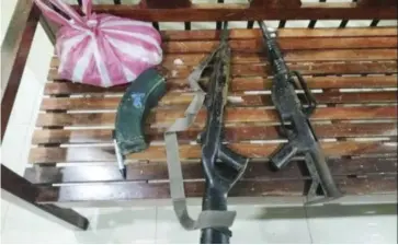  ?? ?? Law enforcers recovered firearms in a house on May 9, 2022 in Leon, Iloilo. Police provincial director, Colonel Adrian Acollador, said the suspect who eluded arrest served as vice secretary of District Committee II, Southern Front of Komite Rehiyon – Panay of the New Peoples’ Army.