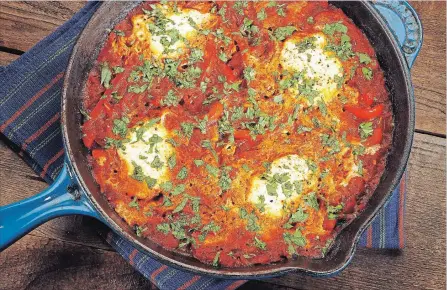  ?? GLENN KOENIG TNS ?? Shakshuka, a Middle Eastern dish that’s essentiall­y eggs cooked in a spicy tomato sauce, is beginning to see a gain in popularity in North America.