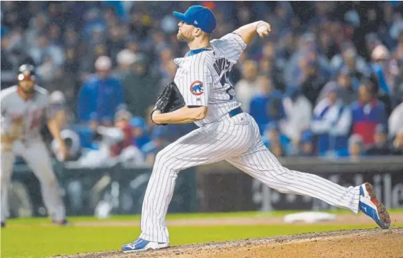  ??  ?? Wade Davis helped the Kansas City Royals win the World Series two years ago. This year, the right-handed reliever pitched for the Chicago Cubs. “There’s a lot to like,” Rockies general manager Jeff Bridich says of Davis, who has a career postseason ERA...