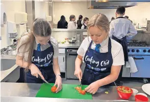  ?? ?? Chop, chop It’s all hands on deck in the college training kitchen