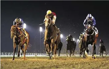  ?? Virendra Saklani/Gulf News Archives ?? Seasonal debut Faulkner (centre), ridden by Pat Dobbs, wins the Longines Saint Imier handicap at the first meeting of 2015 Dubai World Cup Carnival in January. He makes his seasonal debut today.