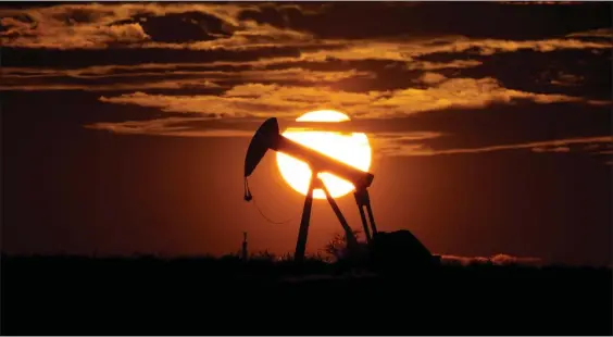  ?? AP FILE ?? The sun sets behind a pump jack. Oil markets have been fluctuatin­g over fears of lost supplies from Russia because of the war in Ukraine.