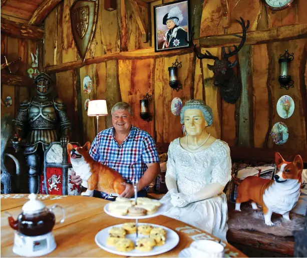  ??  ?? Time for tea, Ma’am: Log cabin is just the spot for scones and a cuppa with lifesize model of the Queen and her corgis