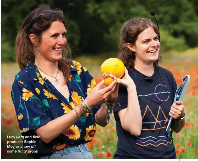  ?? ?? Lucy (left) and field producer Sophie Meyjes show off some fruity props