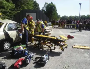  ?? Joseph Fitzgerald photo ?? EMT’s extract a victim from a fatal two-car crash during the Woonsocket Public Safety Division and Education Department’s annual mock crash on Tuesday.