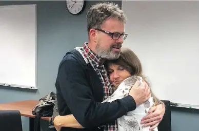  ?? GARRATT FAMILY PHOTO ?? Kevin and Julia Garratt embrace at Vancouver Internatio­nal Airport after his release from a prison in China.