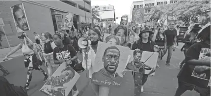  ?? JULIO CORTEZ/AP ?? Protesters march June 25 after former Minneapoli­s police officer Derek Chauvin was sentenced to 221⁄ years in prison for
2 the murder of George Floyd, in Minneapoli­s.