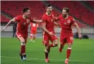  ??  ?? Robert Lewandowsk­i celebrates with his Poland teammates after his fine late equaliser in Budapest. Photograph: Zsolt Szigetváry/EPA