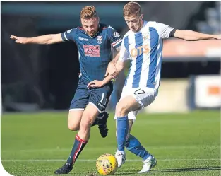  ??  ?? Ross County’s Craig Curran and Killie’s Stuart Findlay compete for the ball