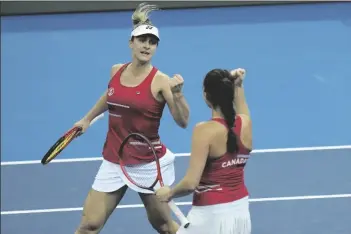  ?? PETR DAVID JOSEK/AP ?? CANADA’S REBECCA MARINO (RIGHT) AND GABRIELA DABROWSKI celebrate after defeating Alize Cornet and Clara Burrel of France in their group A Billie Jean King Cup finals tennis match in Prague, Czech Republic Monday.