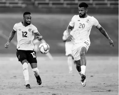  ?? FILE ?? Jamaica’s Junior Flemmings (left) sets himself to play the ball while under pressure from Panama’s Anibal Goday Lemus during a Concacaf World Cup qualificat­ion match at the National Stadium on September 5.