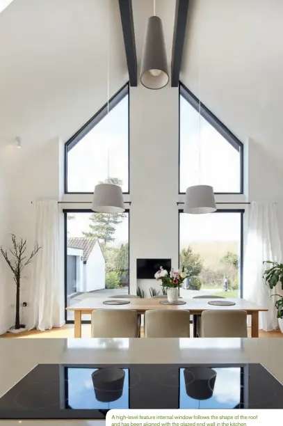  ??  ?? A high-level feature internal window follows the shape of the roof and has been aligned with the glazed end wall in the kitchen