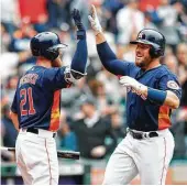  ?? Brett Coomer / Houston Chronicle ?? The Astros had no extra-base hits in their series with San Diego until Max Stassi, greeted by Derek Fisher (21), went deep in Sunday’s fifth inning.