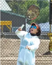  ??  ?? Shelley Shen sends a high return back over the net on Saturday afternoon.