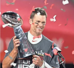  ?? MATTHEW EMMONS/USA TODAY SPORTS ?? Buccaneers quarterbac­k Tom Brady holds the Vince Lombardi Trophy after defeating the Chiefs in Super Bowl LV on Feb. 7.