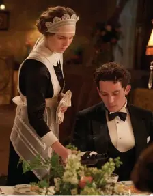  ?? Sony piCtures ClAssiCs ?? IN UNIFORM: Jane Fairchild (Odessa Young) serves Paul Sheringham (Josh O’Connor) at dinner.
