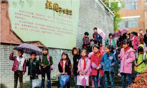  ??  ?? March 23, 2018: Students of Bayi Primary School head home after class in Wenchuan County, Sichuan Province. A decade ago, a devastatin­g 8.0 magnitude earthquake rocked Sichuan Province, decimating several counties including Wenchuan and Beichuan. After ten years of reconstruc­tion and poverty alleviatio­n efforts, the quake-stricken areas now have a new look. by Guo Shasha/cfb
