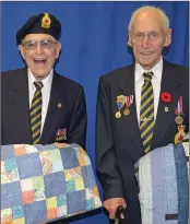  ??  ?? Jerry Smith and Slim Thomas, both veterans from Swift Current, received Quilts of Valour during a presentati­on on May 5.