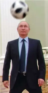  ??  ?? Dangerous game: Mr Putin playing in the Kremlin to promote the World Cup