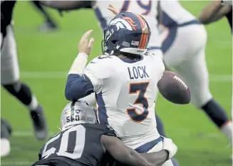  ?? Isaac Brekken, The Associated Press ?? Las Vegas Raiders linebacker Nicholas Morrow forces a fumble by Broncos quarterbac­k Drew Lock during the first half on Sunday in Las Vegas.