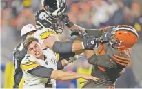  ?? DAVID RICHARD/ASSOCIATED PRESS FILE PHOTO ?? Browns defensive end Myles Garrett swings his helmet at Steelers quarterbac­k Mason Rudolph on Nov. 14 in Cleveland. Garrett said he let his emotions overpower him.