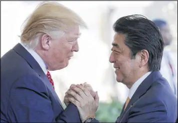  ?? MARIO TAMA / GETTY IMAGES ?? President Donald Trump greets Japanese Prime Minister Shinzo Abe as he arrives Friday at the White House in Washington, D.C. Abe invited Trump to visit Japan this year, and Trump accepted.