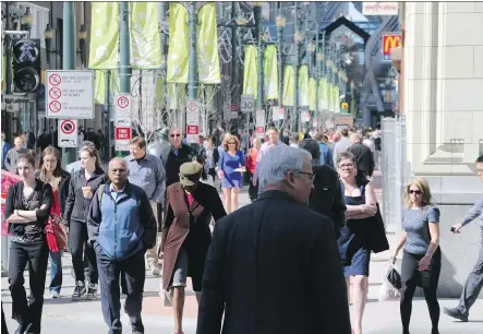  ?? GAVIN YOUNG/ CALGARY HERALD ?? Stephen Avenue at 1st Street S. W. is packed with pedestrian­s at lunchtime on Thursday.