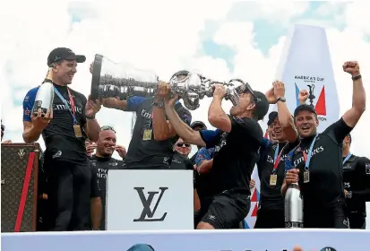  ?? GETTY IMAGES ?? Shore team boss Sean Regan drinks champagne out of the America’s Cup as Emirates Team New Zealand celebrate their victory in Bermuda.