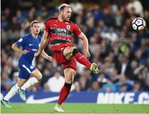  ?? — AP ?? Easy does it: Huddersfie­ld’s Laurent Depoitre scoring the goal against Chelsea in the Premier League match at Stamford Bridge on Wednesday.