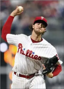  ?? DERIK HAMILTON — THE ASSOCIATED PRESS ?? Phillies starting pitcher Aaron Nola uncorks a pitch in the fourth inning at Citizens Bank Park Friday night. Nola and the Phils beat the Braves 7-3.