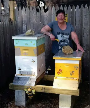  ?? Submitted Photo ?? Above, Deadra Bonenfant smiles for a photo with her two honeybee hives. Below, a queen bee and her colony work on developing a honeycomb. The queen bee is the larger insect in the photo with a dark abdomen.