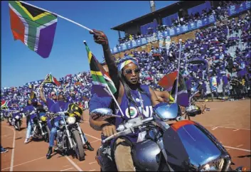  ?? Jerome Delay The Associated Press ?? Democratic Alliance supporters on motorcycle­s cheer leader Mmusi Maimane as he arrives at a rally Satruday at the Dobsonvill­e Stadium in Johannesbu­rg.