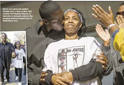  ??  ?? Pierre Lacy gives his mother, Claudia Lacy, a kiss as they rally outside First Baptist Church on Saturday to demand action in the hanging death of Lennon Lacy in Bladenboro, N.C.