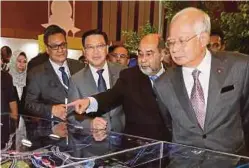  ?? FILE PIX ?? (From left) Defence Minister Datuk Seri Hishammudd­in Hussein launching the Trilateral Air Patrol with his Indonesian and Philippine counterpar­ts; Deputy Prime Minister Datuk Seri Dr Ahmad Zahid Hamidi showing the Big Splash Open Data applicatio­n on his...