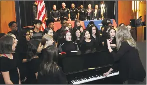  ??  ?? The Ponus Ridge Middle School Choir sings “God Bless America” as the school hosts several veterans to speak with students about their experience­s.