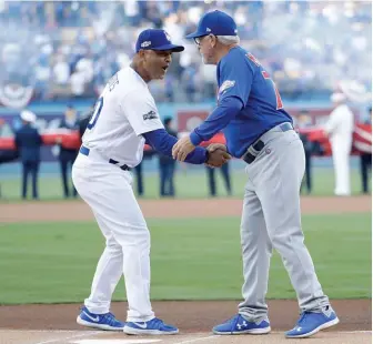  ?? GETTY IMAGES ?? Dodgers manager Dave Roberts (left) and Cubs manager Joe Maddon shake hands before Game 3 of the 2016 NLCS in Los Angeles. The Cubs won the series in six games.