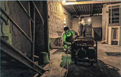  ?? Photo: Dwayne Senior/bloomberg/getty Images ?? Back to basics: Employees at a restaurant in Hout Bay prepare a generator before load-shedding kicks in.