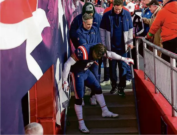  ?? DANIELLE PARHIZKARA­N/GLOBE STAFF ?? Jabrill Peppers, who had a fumble recovery wiped away, struggled to walk down the stairs into the locker room after the game.
