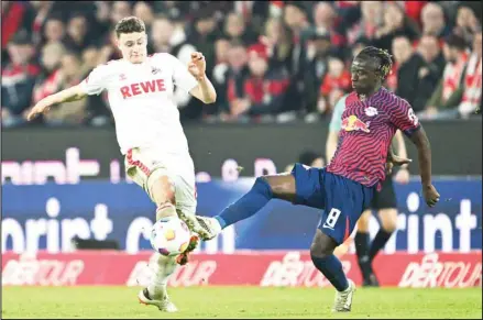  ?? ?? Cologne’s Eric Martel, (left), and Leipzig’s Amadou Haidara battle for the ball during the Bundesliga soccer match between FC Koln and RB Leipzig at Rhein Energie Stadion in Cologne, Germany. (AP)