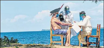  ?? AFP ?? An indigenous chief takes a coronaviru­s test on the banks of the lower Tapajos River in Brazil.