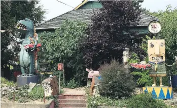  ?? ANNIE GROER/WASHINGTON POST ?? Junk sculptures of Godzilla and a car salesman stand in the front yard of Patrick Amiot and Brigitte Laurent on Florence Avenue in Sebastopol, Calif.